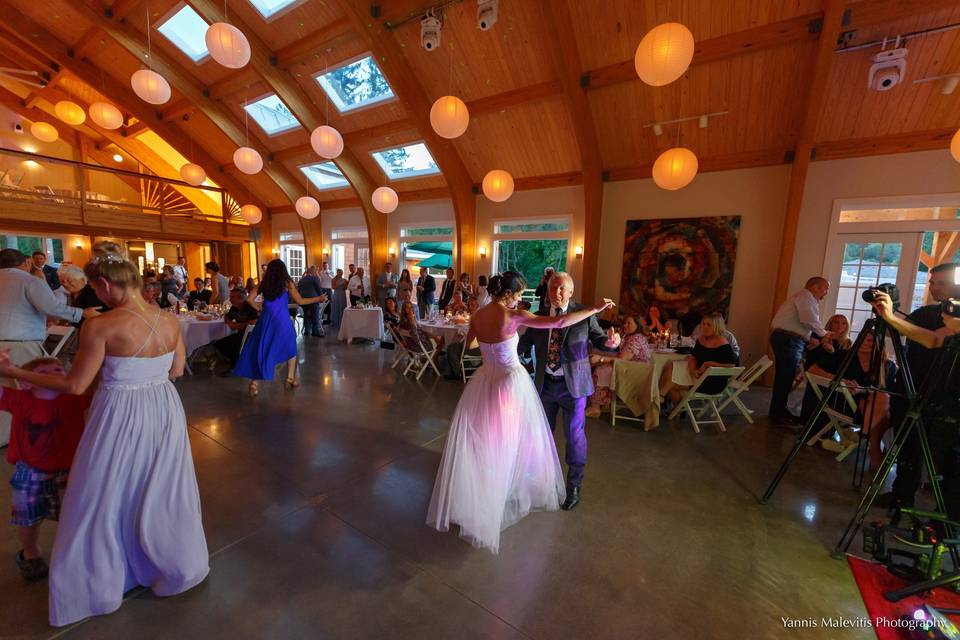 An enchanting bride and her father share a magical dance in the pavilion, surrounded by their loved ones.