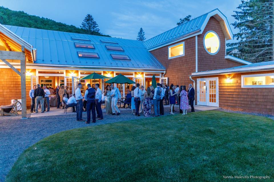 An evening cocktail party begins outside the pavilion.