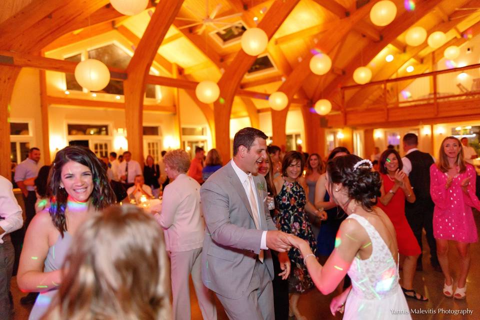 A joyful bride and groom get the dancing started at their fun-filled wedding reception!