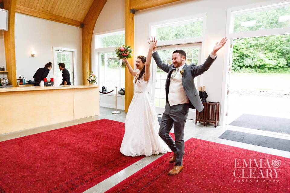 The happy couple enters the new pavilion to greet their guests as husband and wife