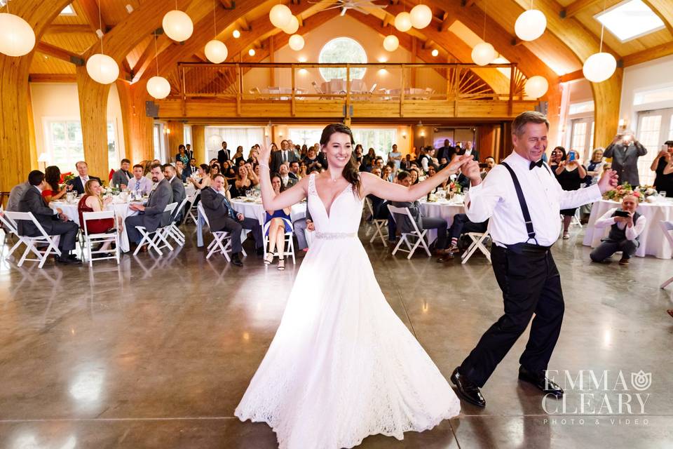 A radiant bride sharing a dance with her father in the new pavilion