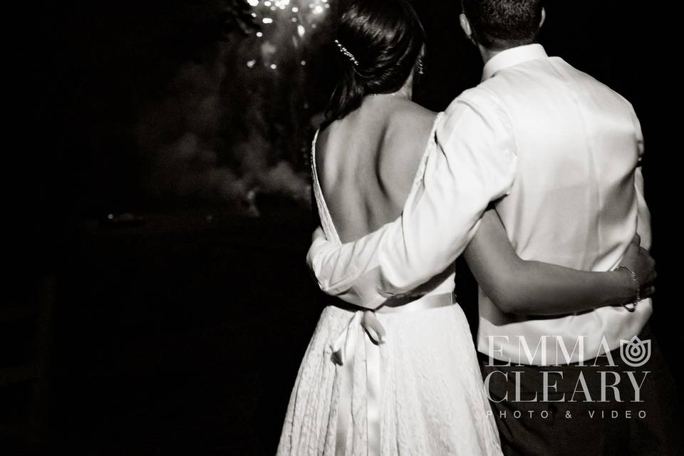 A joyful bride and groom observe the fireworks display designed just for them