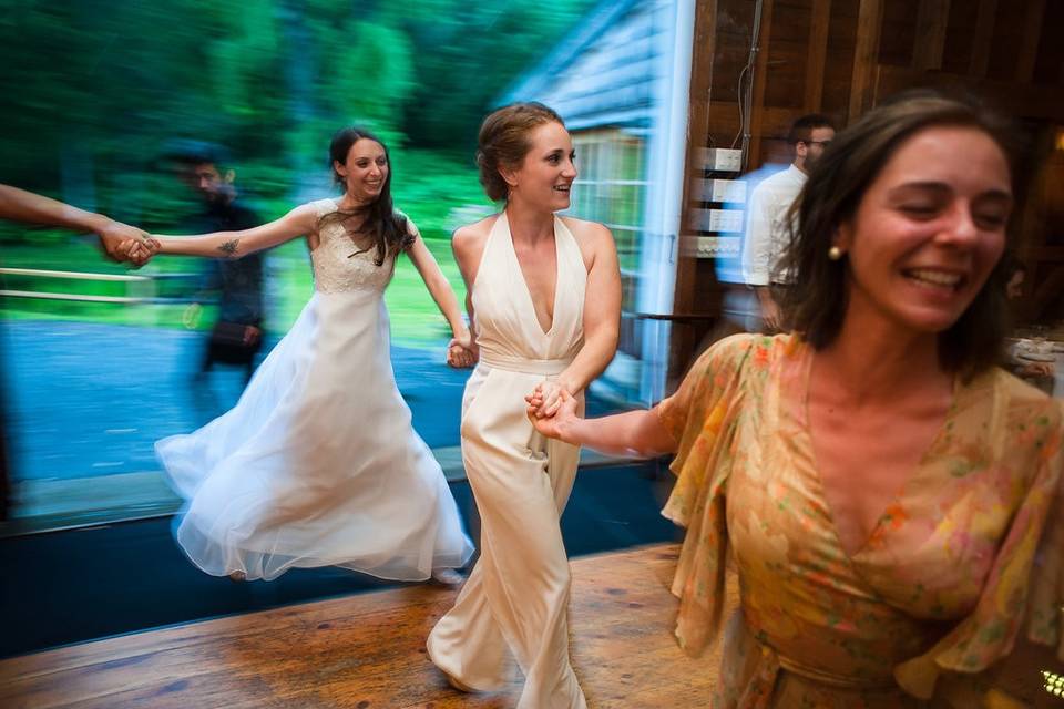 A high-spirited couple joining hands to embrace the precious gift of their first dance as husband and wife