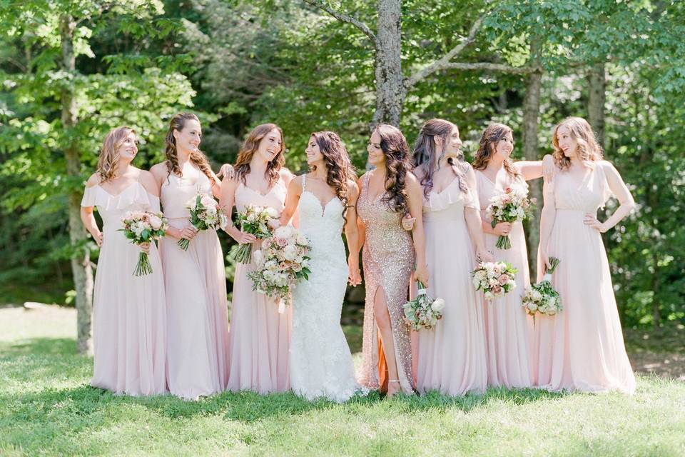 Happy bridesmaids on the lawn