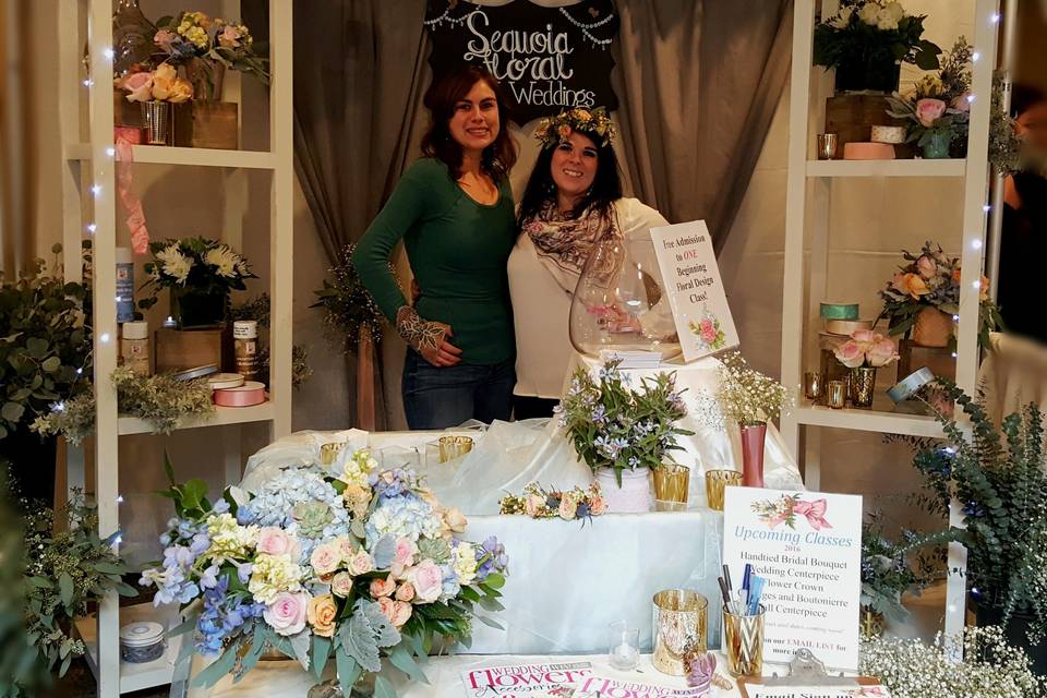 Assistant Store Manager Jennifer Conn (Left) and Second Assistant Store Manager Alyssa DeVincenzi (Right) pictured with booth at the Wedding Expo.