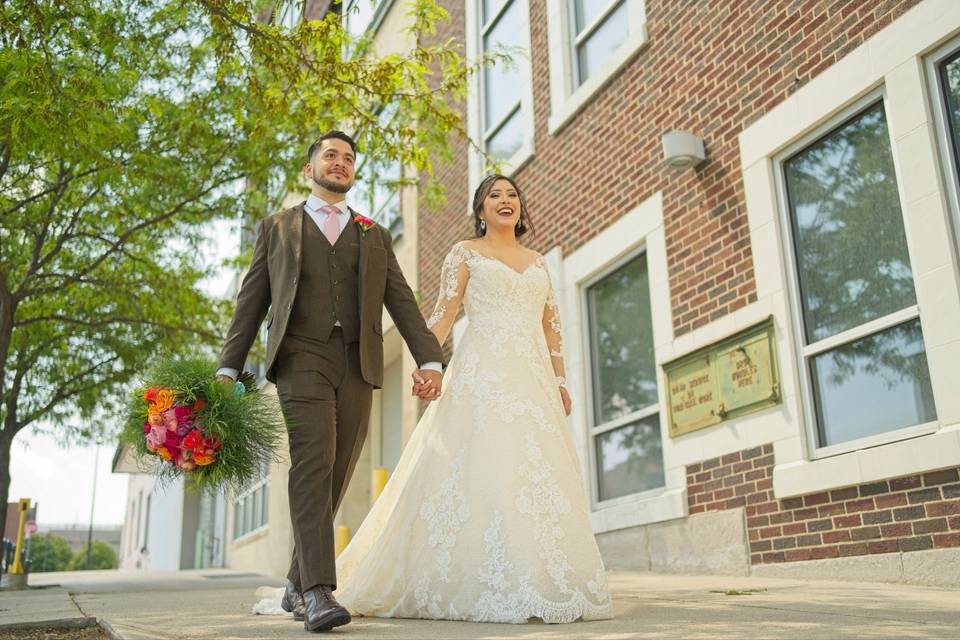 Bride and groom walk downtown