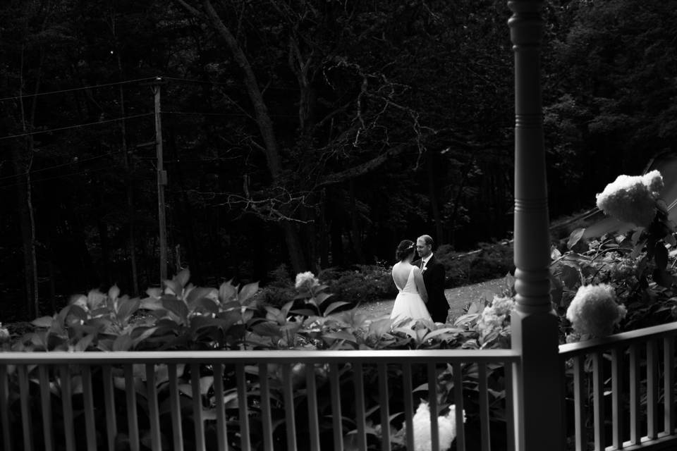 Couple standing between flowers