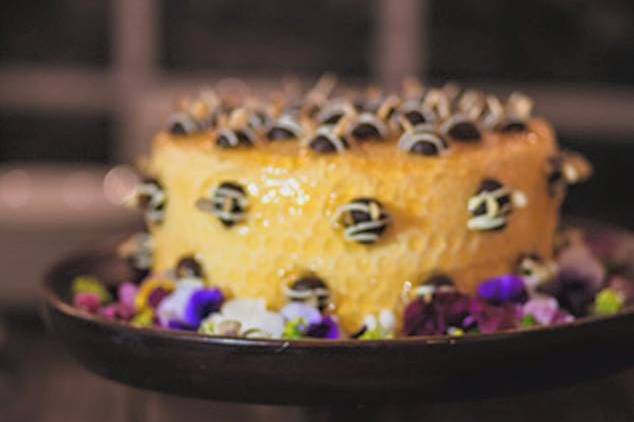 Honey Bee CakeOrange Chiffon Cake layered with Apricot Preserves  , Honey Butter Cream, Apricot Glaze and Chocolate Truffle Bees, Almond wings