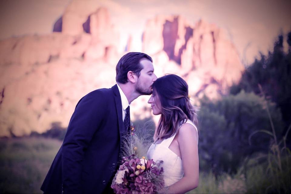 Couple posing in landscape with flowers