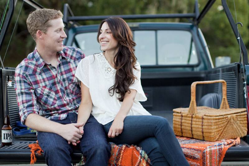 Fishing engagement session, couple on truck tailgate