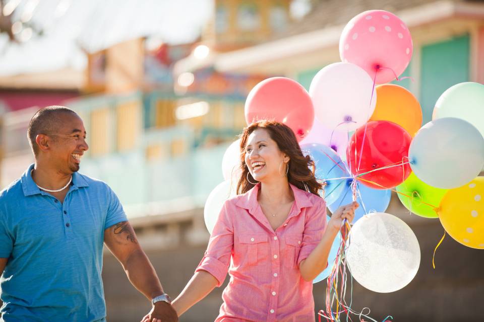 Santa Cruz beach boardwalk engagement session with cotton candy and balloons