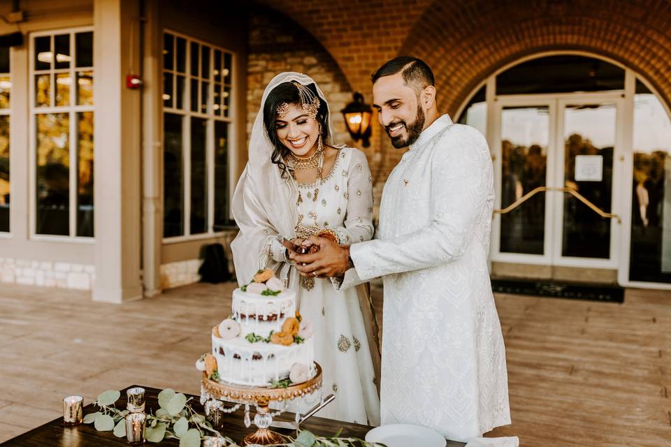 Bride and Groom Cutting Cake