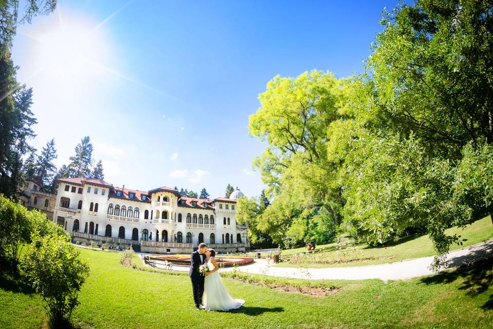 Couple beside a mansion