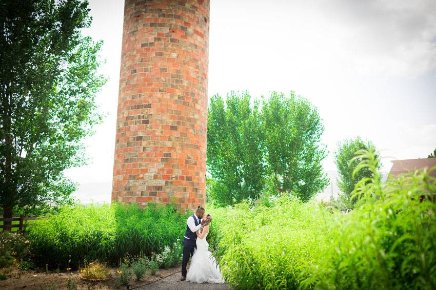 Couple kiss beside a tower