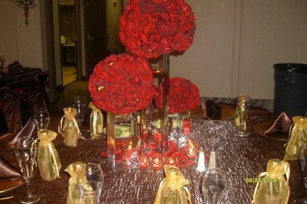 Black Magic, Black Baccara and Burgundy Carnations create a grand Tri-Vase centerpiece.