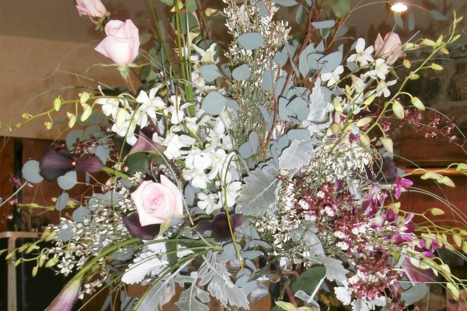 Centerpiece with orchids, roses, and calla lilies