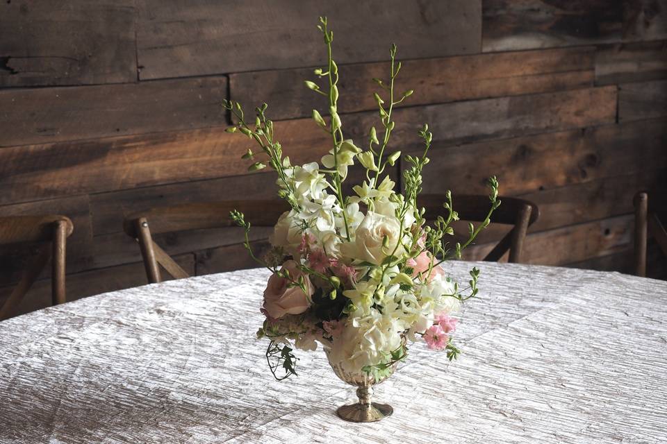 Centerpiece with larkspur, hydrangea and roses