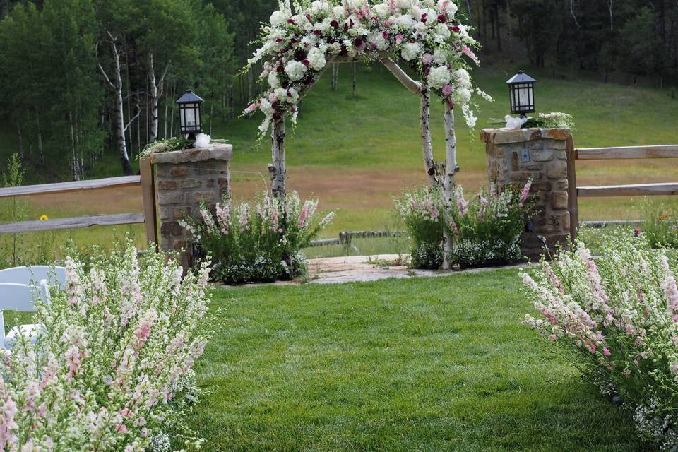 Wild Canyon Ranch entry with larkspur, hydrangea and roses