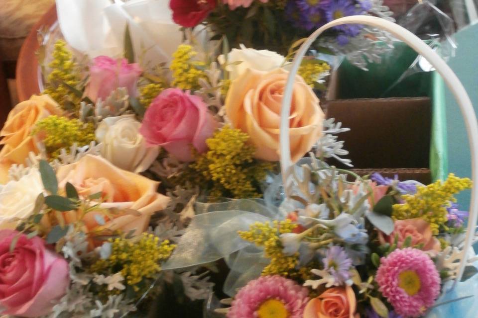 Pastel assortment of roses, asters, delphinium, gerbera daisies and solidago