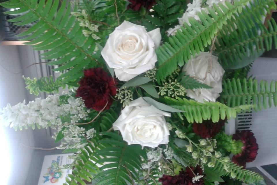 Lush greenery with roses and carnations