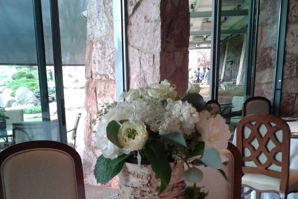 Tall hydrangea and assorted flowers in birch cylinder centerpiece