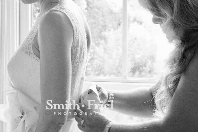 The bride putting on her dress