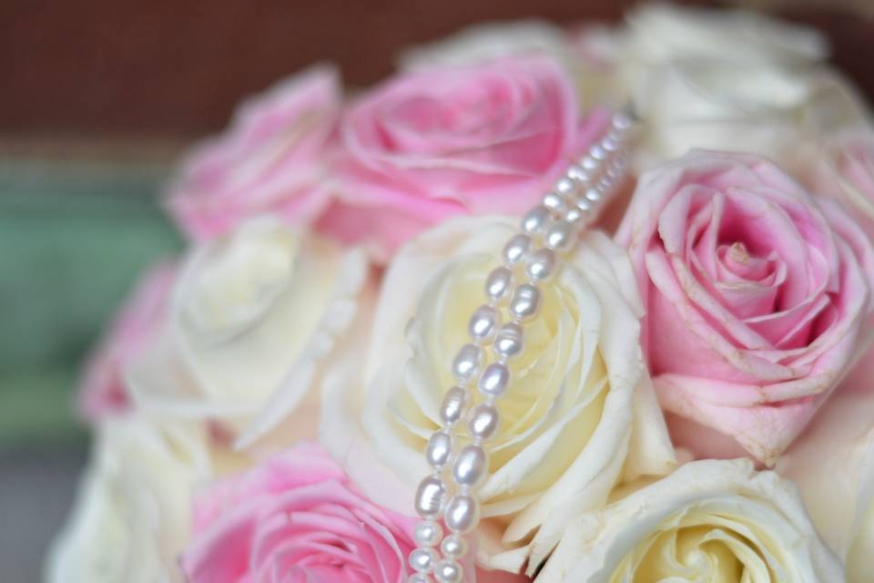 This bride wanted a simple and classic bracelet to complement her romantic New York Wedding. With the ladies adorned in fascinator hats, her bridal style was classic and perfect. She wore a two strand freshwater pearl bracelet with a vintage clasp.
Her Maid of Honor dressed up her blush bridesmaid dress with a custom vintage rhinestone freshwater pearl bracelet in chic grey pearls.  It really popped against her dress.