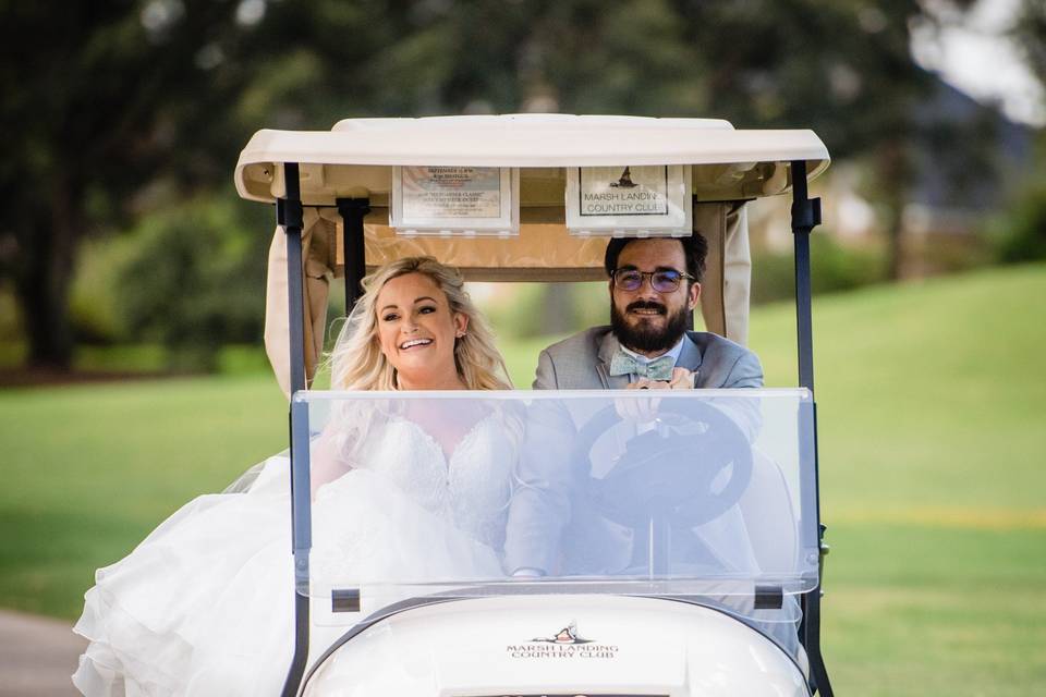 Bride & groom in golf cart