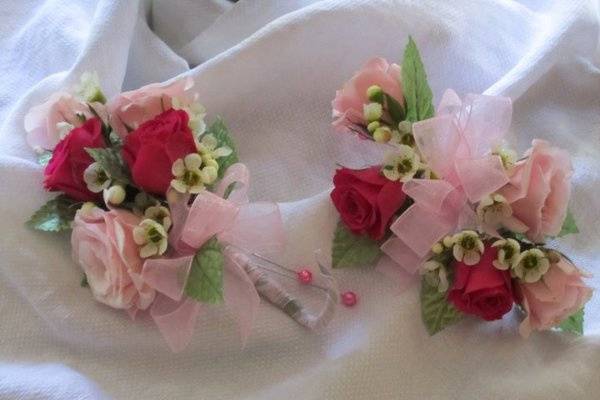 delicate corsages of hot pink and blush pink tea roses.