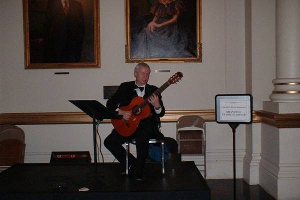 Under the portraits of two truly great arts benefactors!  Nice room, too!