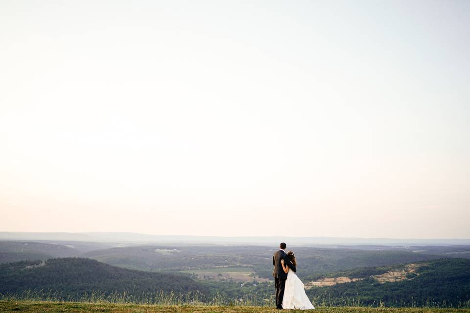 Couple peering out over the valley