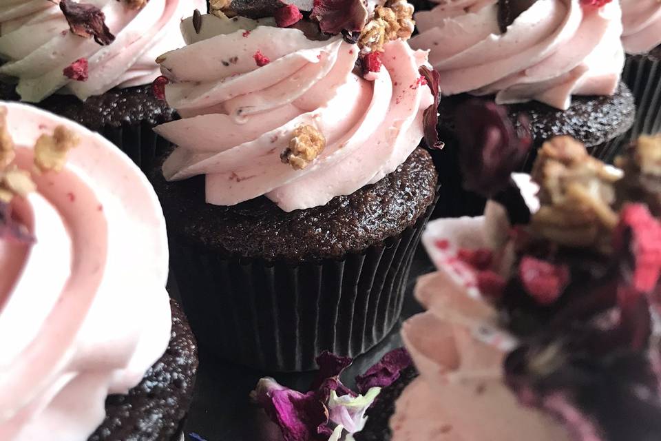 Pink icing on chocolate cupcakes