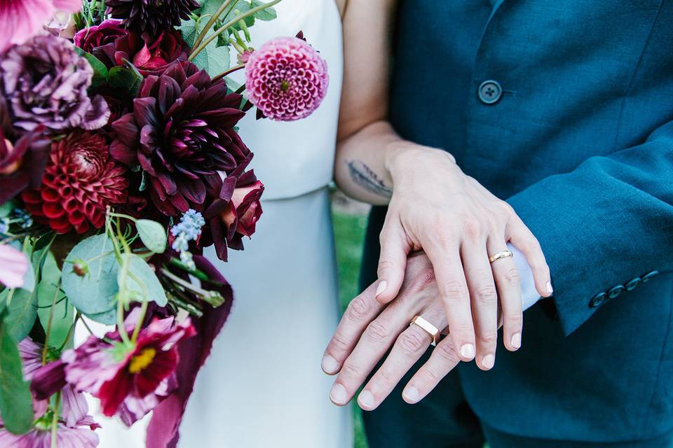 Couple's wedding ring and bouquet