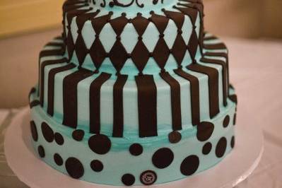 Blue and brown whimsical polka dot, striped, scrolled, diamond design patterned cake.