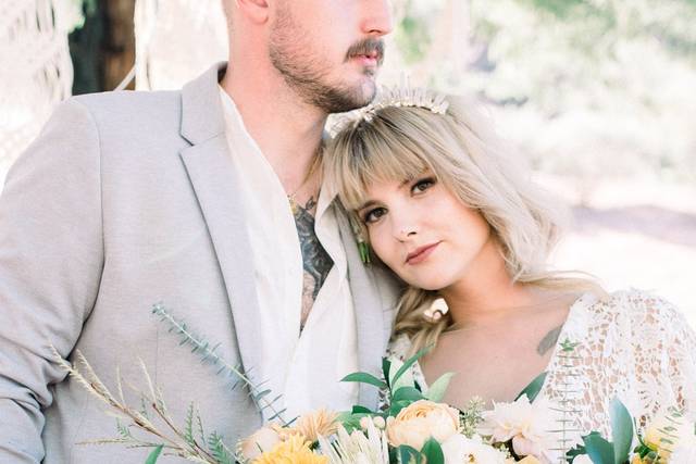 Couple posing with a fresh bouquet