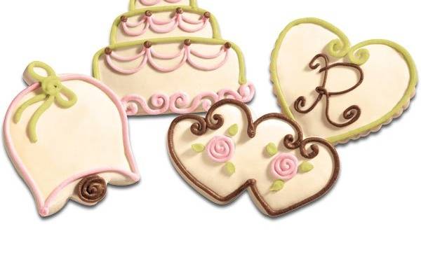 A sweet way to make a lasting impression  wedding cookie favors. Make your wedding shower, engagement party, or wedding reception an event to be remembered with our artfully hand-decorated wedding cookie favors. These unique treats, shaped as double-hearts, wedding bells, hearts, and wedding cakes come decorated in a beautiful pearl with light pink, spring green, and brown accents. Cookies will arrive boxed per dozen. Minimum 12 cookies per order.