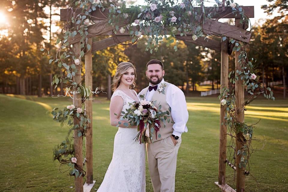 Couple under the wedding arch