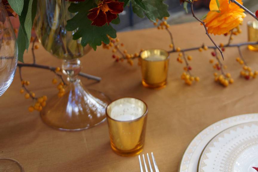 Grace Kim Floral & Event Design- orange & gold centerpiece: cymbidium orchids, marigolds, weber tulips, ranunculus, sage, japanese maple branches, bittersweet branches