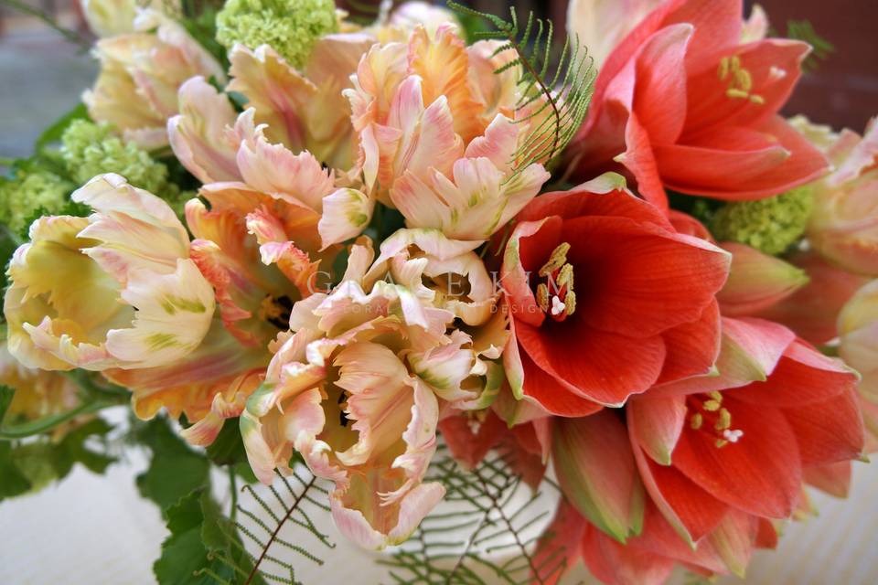 Grace Kim Floral & Event Design- orange centerpiece: amaryllis, parrot tulips, viburnum, geranium, umbrella fern