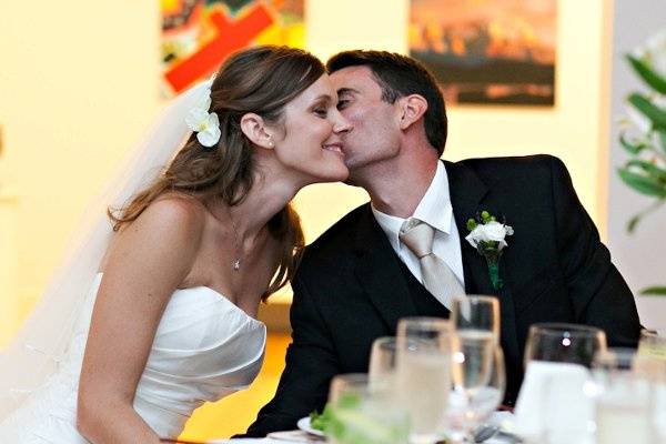 The groom kissing his bride