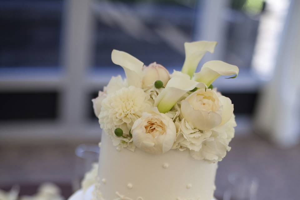Three tier cake with white flowers