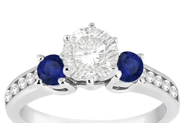 Three-Stone Sapphire & Diamond Engagement Ring	10 channel set diamonds & 2 sapphires accent your choice of center stone. Choose a band of platinum, palladium, or gold.