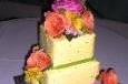 Yellow buttercream covered cake with quilt pattern impression, edible silver dragees and fresh flowers.