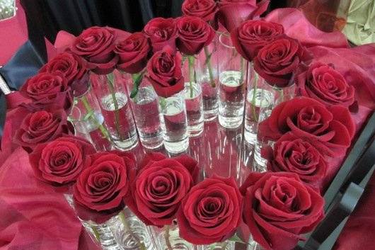 roses in bud vases shaped like a heart