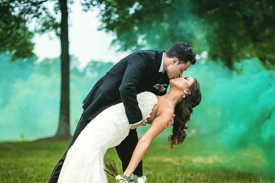 Groom dips his bride for a kiss