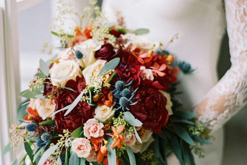 Sleeved bridal dress and wedding bouquet