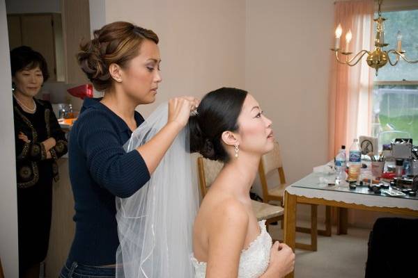 Bride putting on her veil