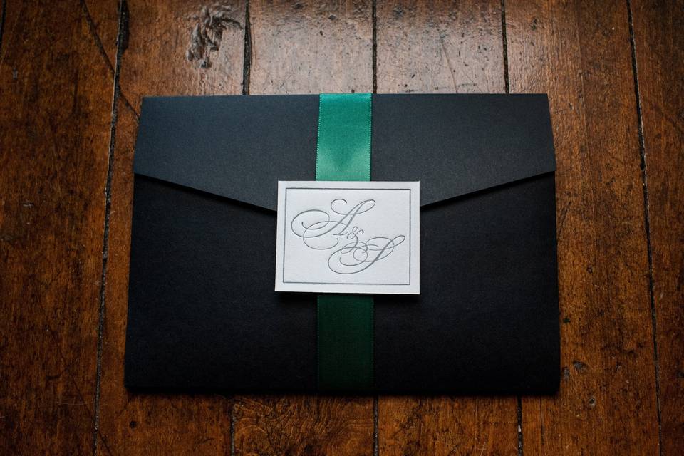 Black envelope and green ribbon