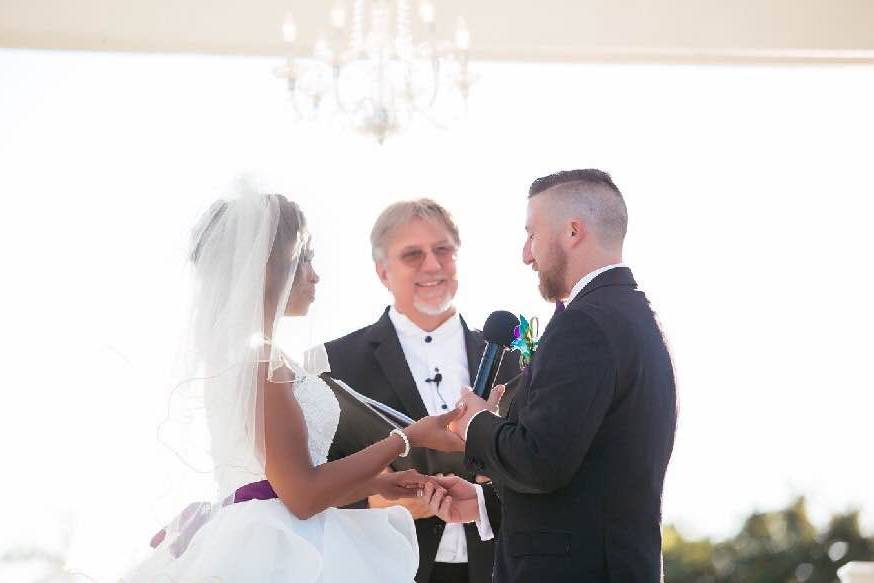 Groom placing the Wedding Band