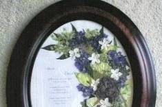 invitation surrounded by the bride's flowers and the groom's boutonniere at the bottom